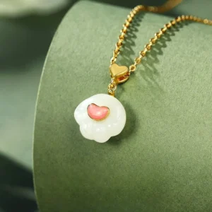 Cat paw jade luck necklace side profile showing delicate silver chain and jade pendant with heart clasp