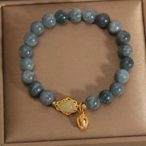 Flat lay of authentic jade beaded bracelet with gourd and light jade center charm inside presentation box