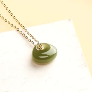Natural hetian jade donut pendant necklace side profile angle showing pendant depth and delicate chain detail