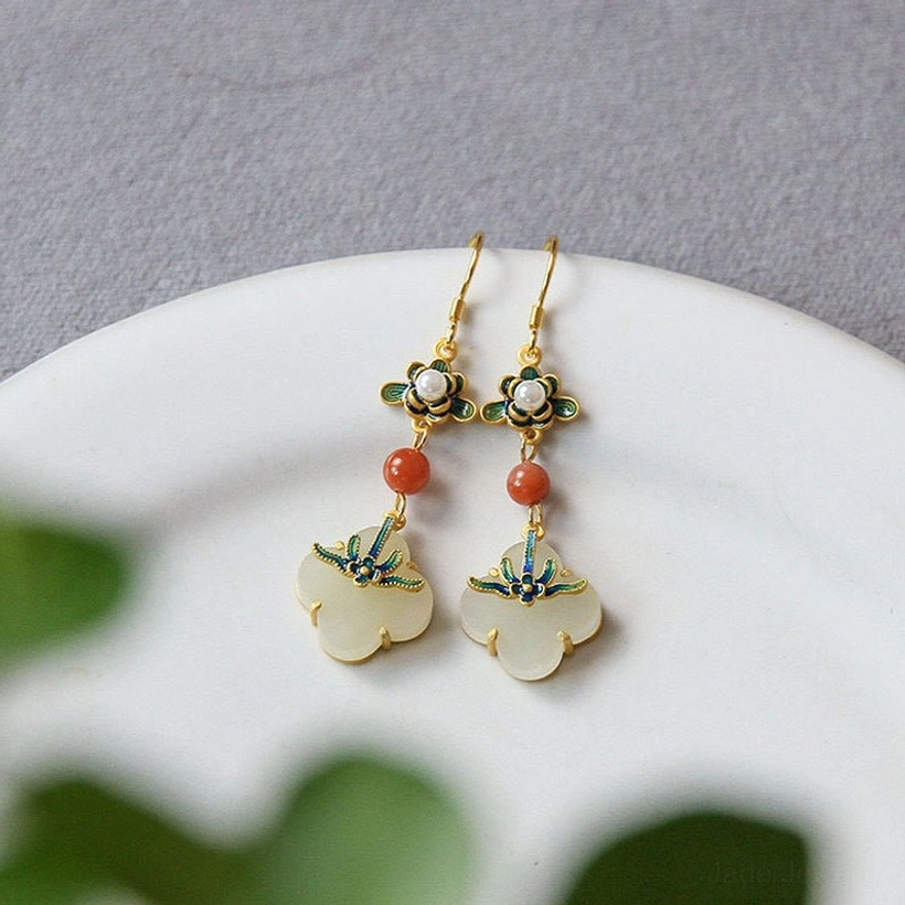 Jade clover drop earrings close-up detail showing gold hooks cloisonné enamel and milky white jade pendant