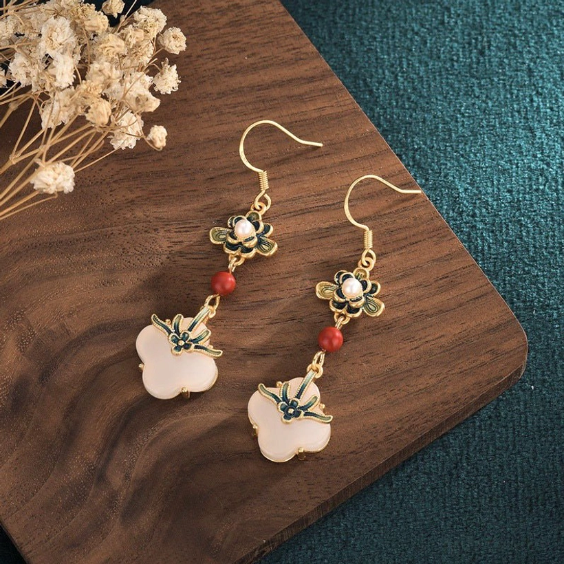 Handmade jade clover drop earrings with pearl accent and red agate bead flat lay styling