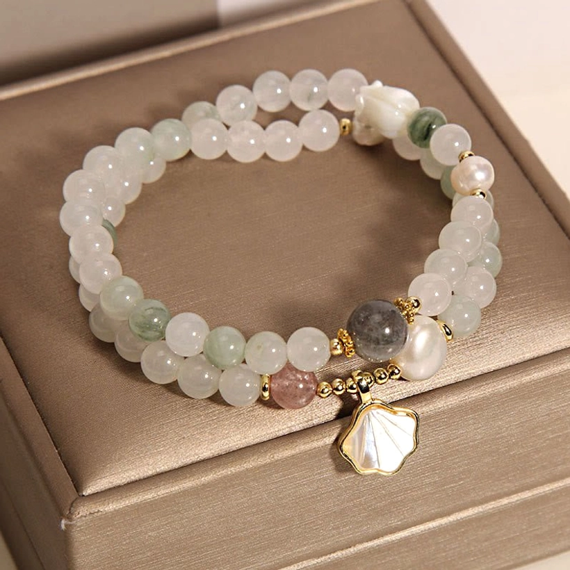 Mixed pale stone jade beads with mother-of-pearl shell pendant and pearl accents overhead view