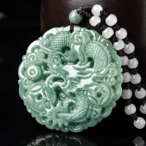 Jade dragon pendant necklace - left overhead view showing intricate dragon carving with cloud patterns on natural green jade