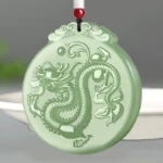 Hand-carved natural jade dragon pendant with cloud motif, top-down studio view showing full dragon relief and cloud-patterned hanger