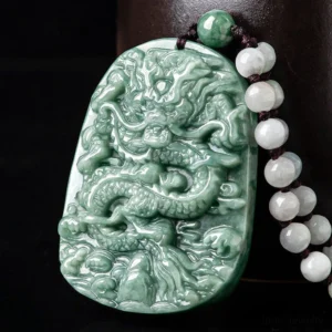 Deep green jade dragon pendant necklace with relief-carved design and beaded cord