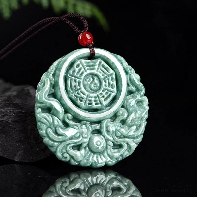 Mirrored reflection of jade dragon yin yang pendant showing carved front and back surfaces