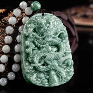 Hand-carved jade dragon pendant showing intricate relief artwork on dark background