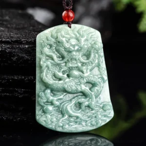 Jade dragon pendant necklace side angle showing intricate relief carving and muted green jade texture