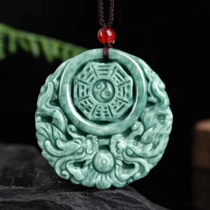 Green jade dragon yin yang necklace pendant with red accent bead on brown cord - front view