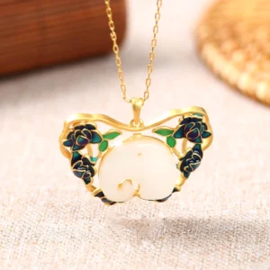 Handmade white jade butterfly elephant pendant on gold chain with blue cloisonné rose accents, overhead flat lay