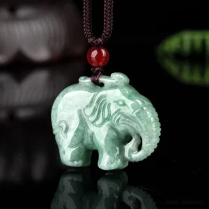 Carved jade elephant necklace side view showing detailed reverse carving, authentic brown rope cord with red bead decoration and artisan craftsmanship