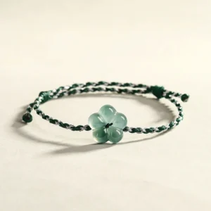 Hand-woven jade flower bracelet with adjustable elastic cord - side view showing natural jade charm detail