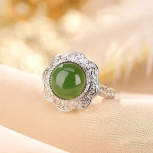 Adjustable Jade Ring with Intricate Silver Filigree - overhead angle detail of carved silver rim and smooth green jade cabochon