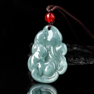 Carved jade nine-tailed fox pendant showing intricate fox carving detail on black reflective background