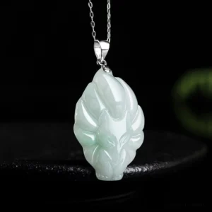Nine-tailed fox jade pendant necklace side angle, polished light green jadeite with detailed tail carving and silver chain