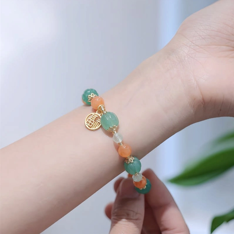 Fu character jade bracelet worn on wrist, showing natural fit and side view of charm on living model