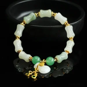 Jade bracelet with Fu charm pendant and mixed white and light green bamboo beads - top down flat lay