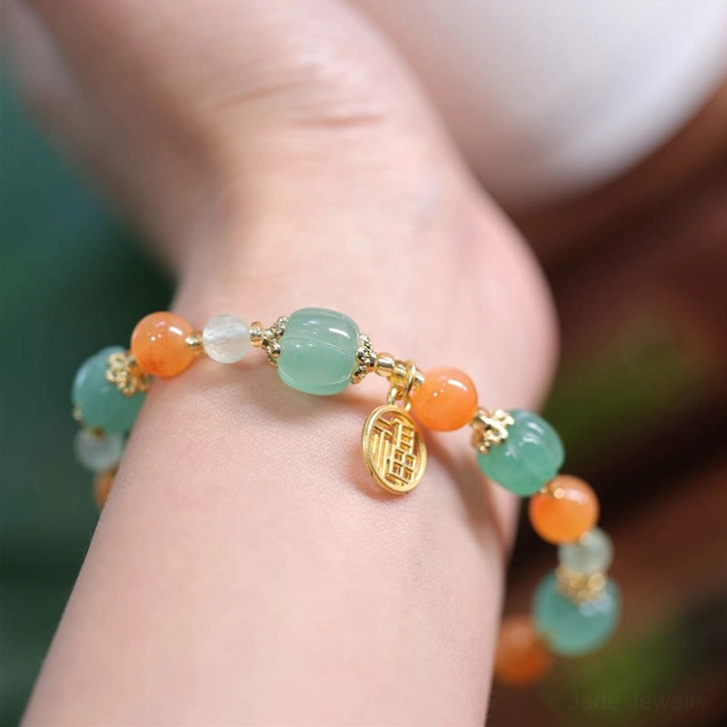 Golden Silk Jade Fu charm bracelet close-up front wrist view, displaying mixed colored gemstone beads on active wearer