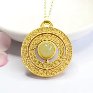 Gold-plated rotatable jade Fu pendant necklace flat lay, showing detailed blessing carvings on frame with central light green jade and attached gold chain