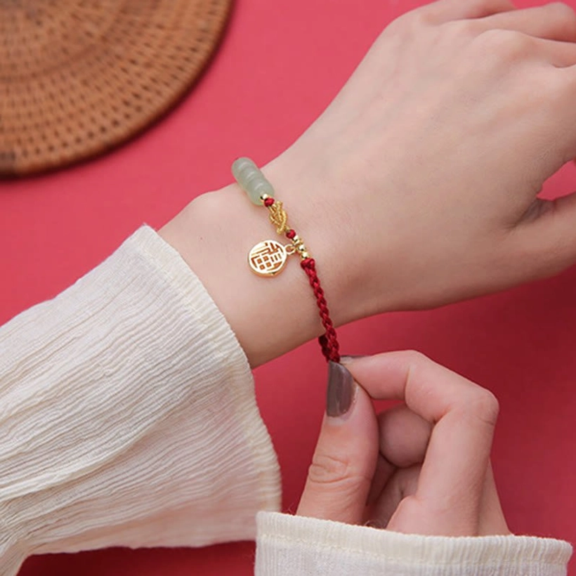 Handcrafted jade Fu bracelet with red cord - natural stone bead styling and gold Fu pendant for prosperity and blessings