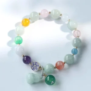 Calabash charm beaded bracelet with pink crystal accents and jade stones, flat lay photography
