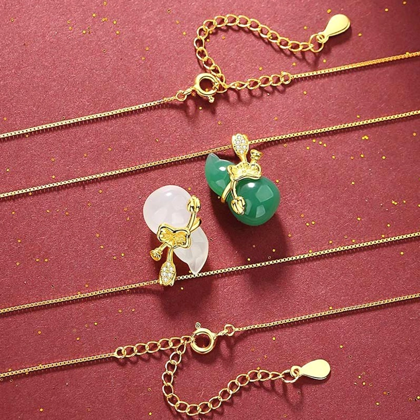 Assorted jade gourd pendant necklaces in cyan and white with adjustable 925 sterling silver gold-plated chains, flat lay