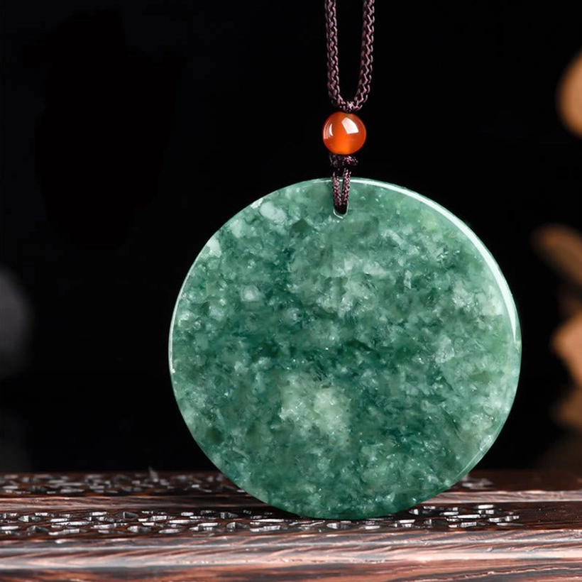 Back view of jade kirin pendant necklace on display showing uncarved smooth jade reverse