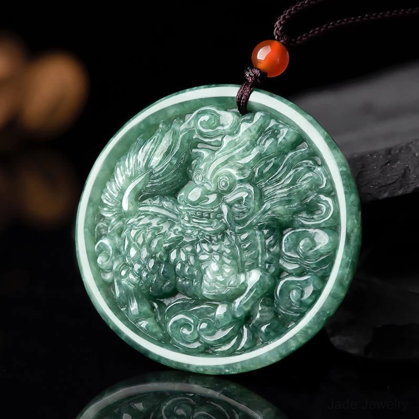 Natural jade kirin pendant necklace with intricate carved design and mottled green jade, front overhead view