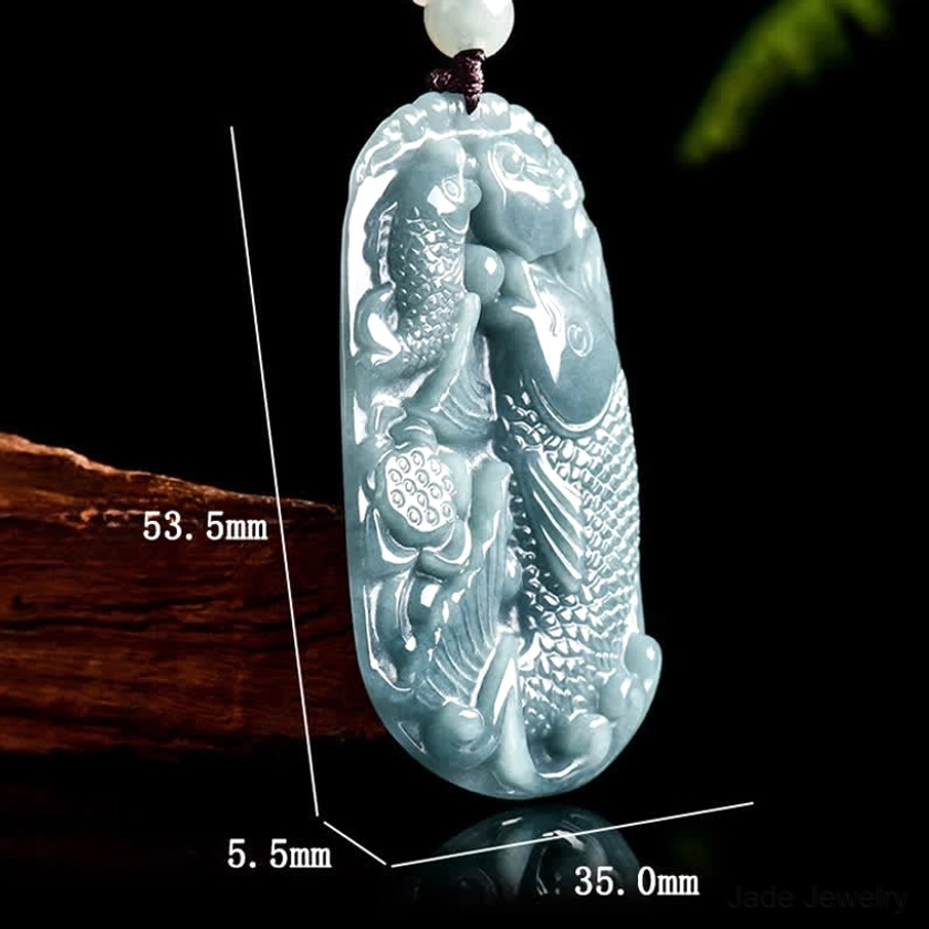 Double koi jade pendant with measurement specifications labeled, side overhead view on wooden display showing 23.62 inch necklace length and detailed pendant dimensions