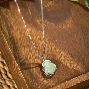 Light green jade Laughing Buddha necklace with silver box chain and rhinestone-trimmed border, product display
