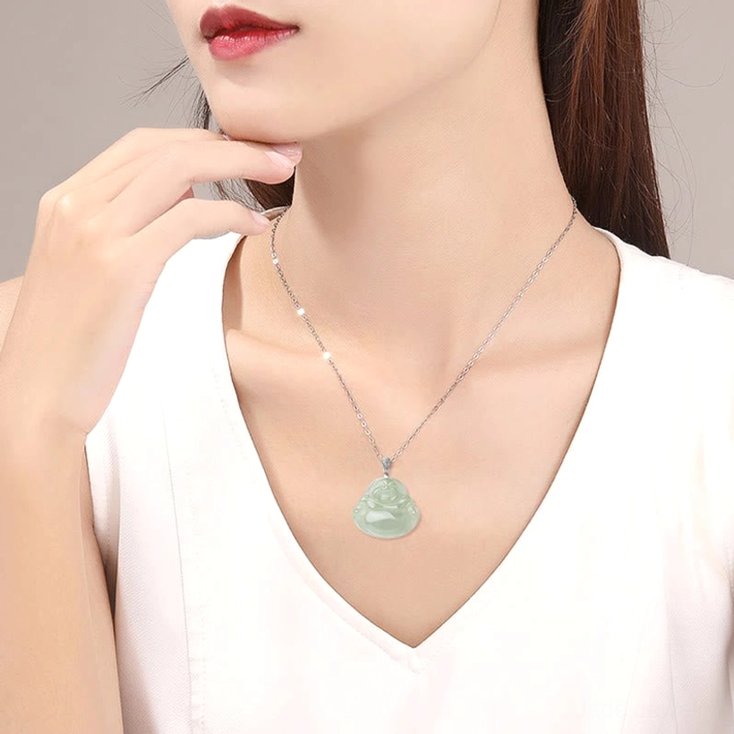 Woman wearing jade laughing Buddha necklace on neck close-up showing dainty silver-toned chain and pendant worn style