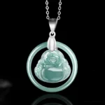 Laughing Buddha jade pendant necklace frontal view on black background, showing teal translucent jade with silver circular frame