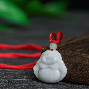 Laughing Buddha jade pendant necklace three-quarter angle view displaying carved details and red braided cord
