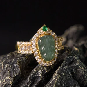 Natural jade leaf diamond ring front three-quarter view showcasing carved green jade stone with gold-plated copper band and cubic zirconia diamond halo setting