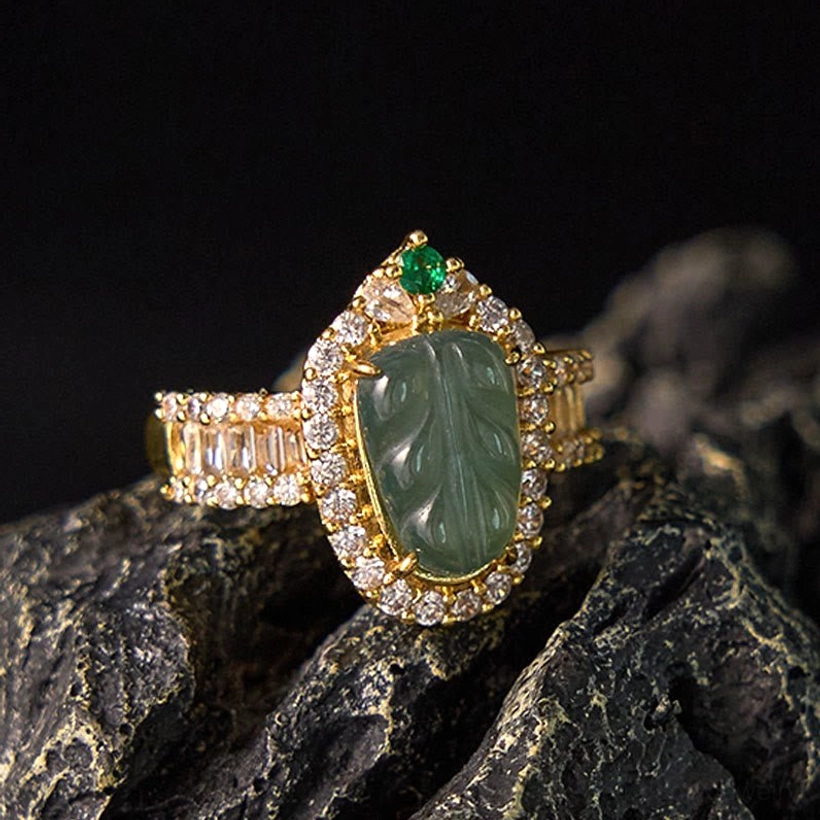 Natural jade leaf diamond ring front three-quarter view showcasing carved green jade stone with gold-plated copper band and cubic zirconia diamond halo setting