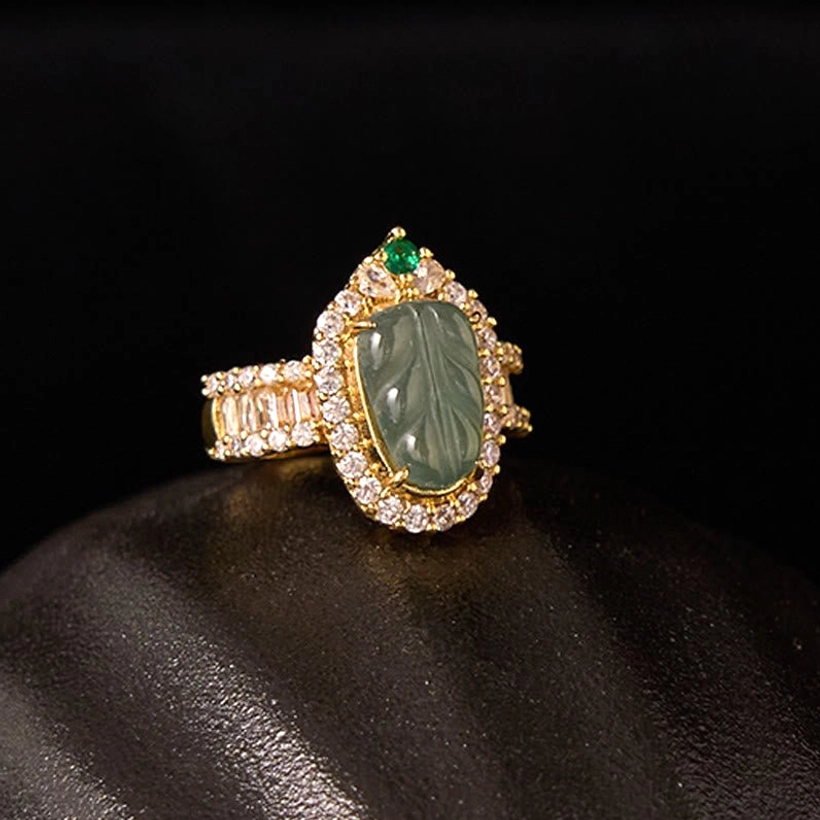 Natural jade leaf adjustable ring close-up detail shot emphasizing the carved jade craftsmanship and gold-plated copper band quality