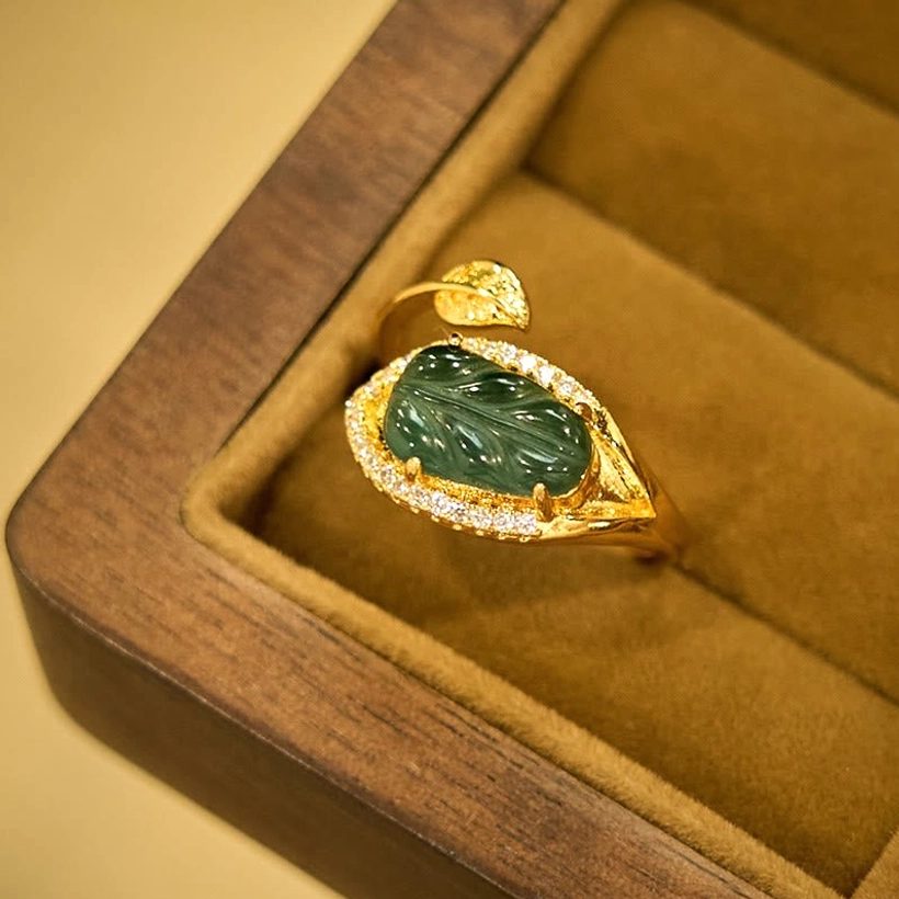 Natural jade leaf prosperity ring detail shot - close-up of carved jade leaf stone and gold-plated copper band craftsmanship