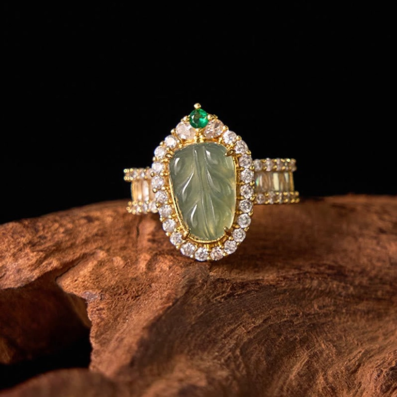 Natural jade leaf diamond ring front top view with clear diamond halo setting and carved green jade leaf focal point on gold band
