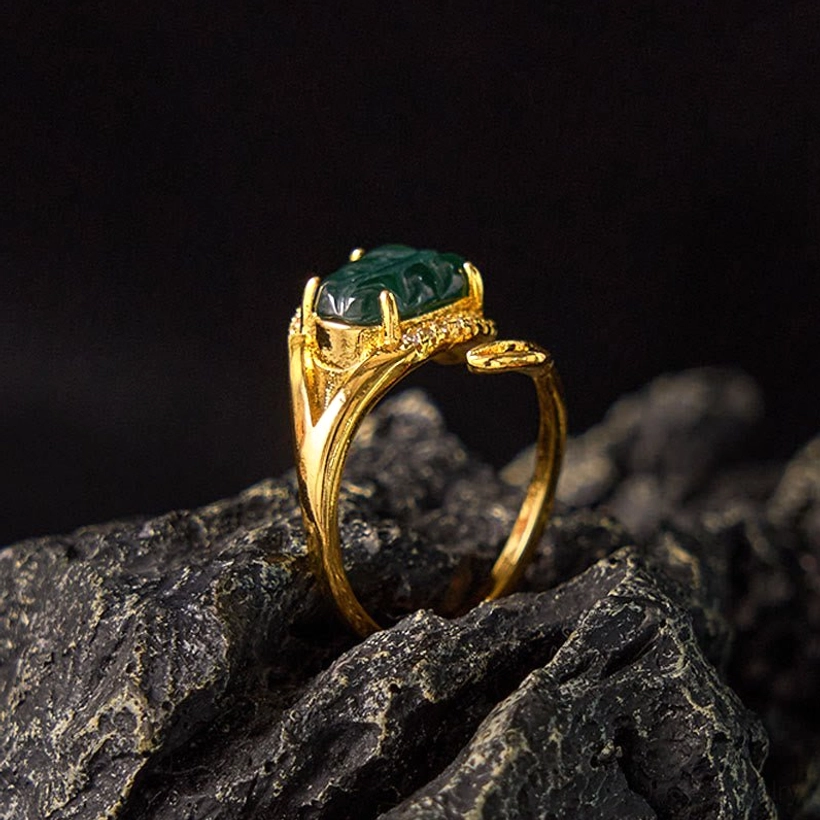 Jade leaf adjustable ring - side three-quarter angle displaying the open adjustable ring shank and detailed jade stone setting against dark textured backdrop