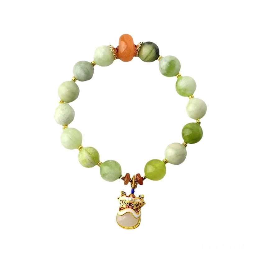 Full overhead view of jade dancing lion charm bracelet on plain light background with gold lion pendant and mixed color beads