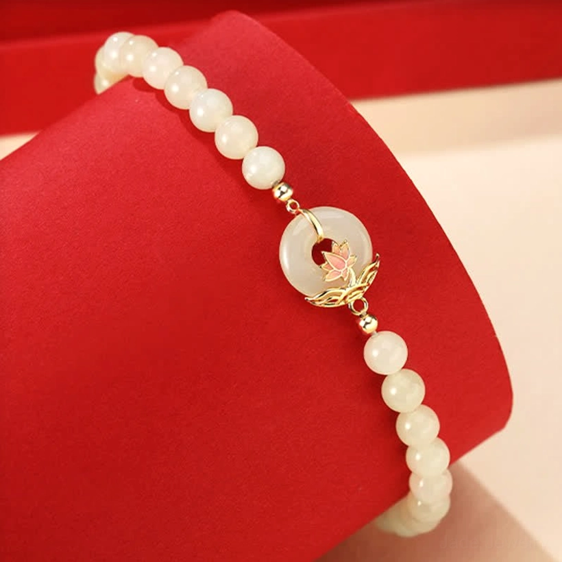 Hetian white jade beaded bracelet with gold-toned lotus peace buckle charm, side view displaying bead details and decorative clasp