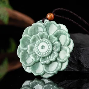Jade lotus pendant necklace with brown waxed cord and orange accent bead, 45-degree side angle showing carved relief and polished natural jade texture