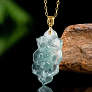 Translucent jade lotus carved pendant necklace three-quarter angle showing delicate floral carving and polished finish with gold hardware