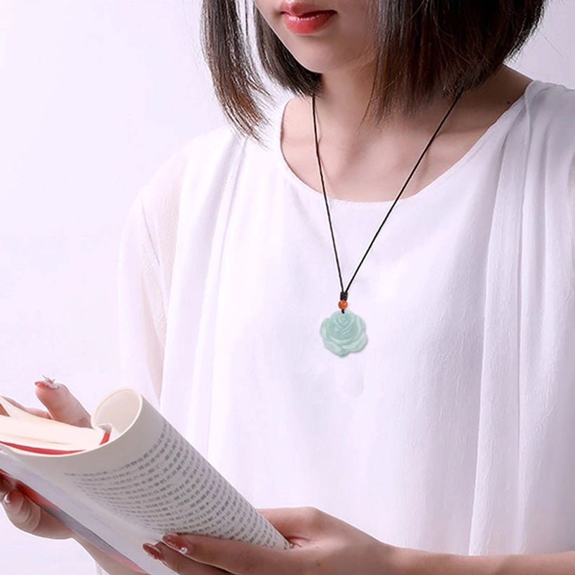 Jade lotus rose pendant necklace worn for daily reading scene, showing natural wearability and comfort