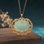 Natural jade lotus pendant necklace with gold-plated copper frame and gemstone accents, front view hanging close-up