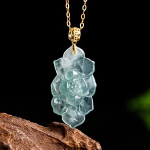 Natural light blue jade lotus flower pendant necklace with gold titanium steel bail close-up front view on wooden display