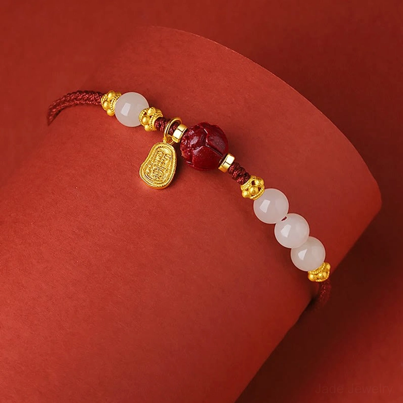 Hetian jade lotus bracelet worn on wrist with dangling gold charm detail