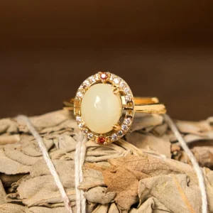 Adjustable open jade ring three-quarter view showing smooth jade cabochon and flexible gold-toned copper band design