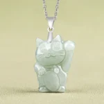 Light green jade lucky cat necklace pendant front view with silver chain and waving prosperity cat design