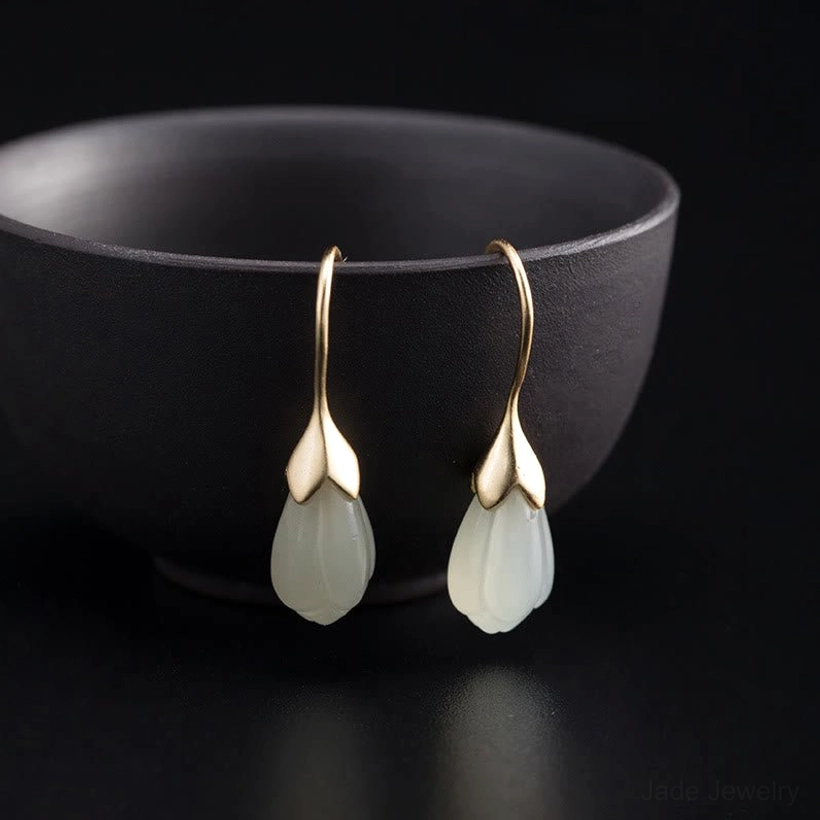 pair of magnolia jade drop earrings displayed on ceramic bowl sterling silver jewelry